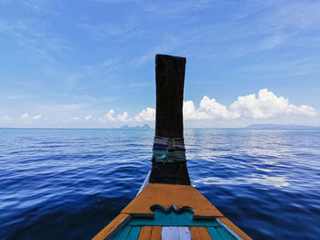 Wooden boat in sea against sky