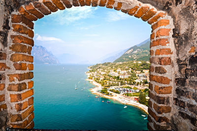 Scenic view of sea against sky seen through window