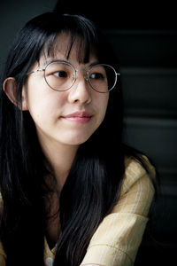 Smiling young woman sitting on steps