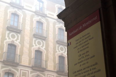 Low angle view of text on building
