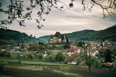 Scenic view of buildings and mountains against sky