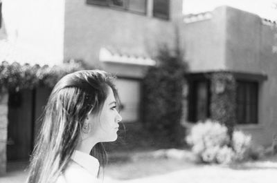 Portrait of young woman looking away outdoors