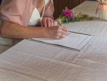 Bride signing document in register office