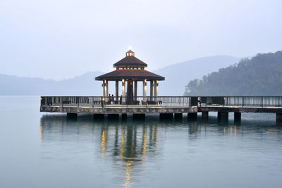 Pier over lake against sky