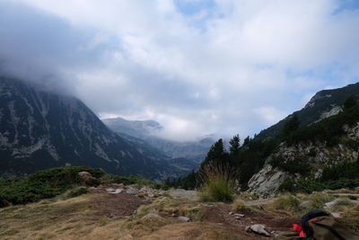 Scenic view of mountains against cloudy sky