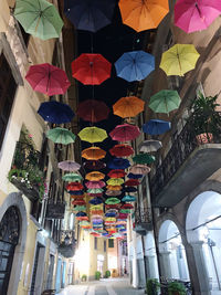 Low angle view of multi colored umbrellas hanging on ceiling