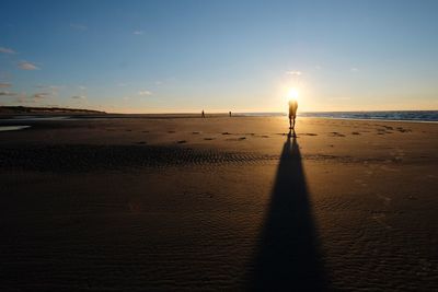 Scenic view of beach against sky during sunset