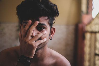 Portrait of young man looking at home