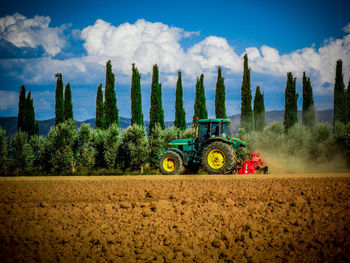 Panoramic shot of tractor on field against sky
