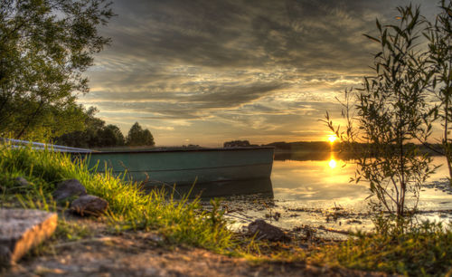 Scenic view of lake against orange sky