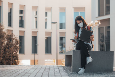 Portrait of young woman using mobile phone