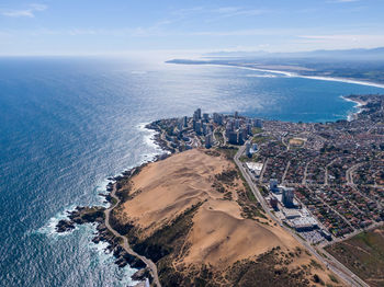 High angle view of sea and buildings against sky