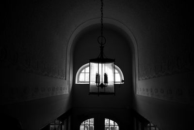 Low angle view of illuminated chandelier hanging in building