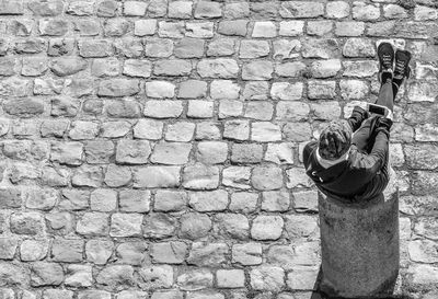 Shadow of woman on brick wall