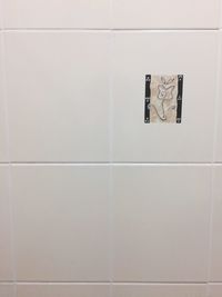 Text on wall in bathroom