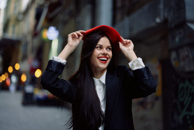 Young woman with arms crossed standing outdoors