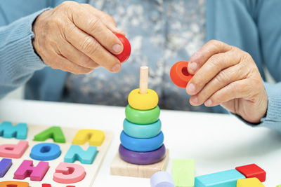Midsection of man playing with toy blocks