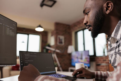 Midsection of man using laptop at office