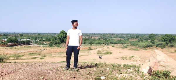 Full length of young man standing on land