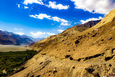 Scenic view of mountains against blue sky