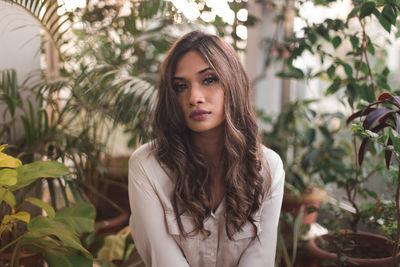 Portrait of woman against plants