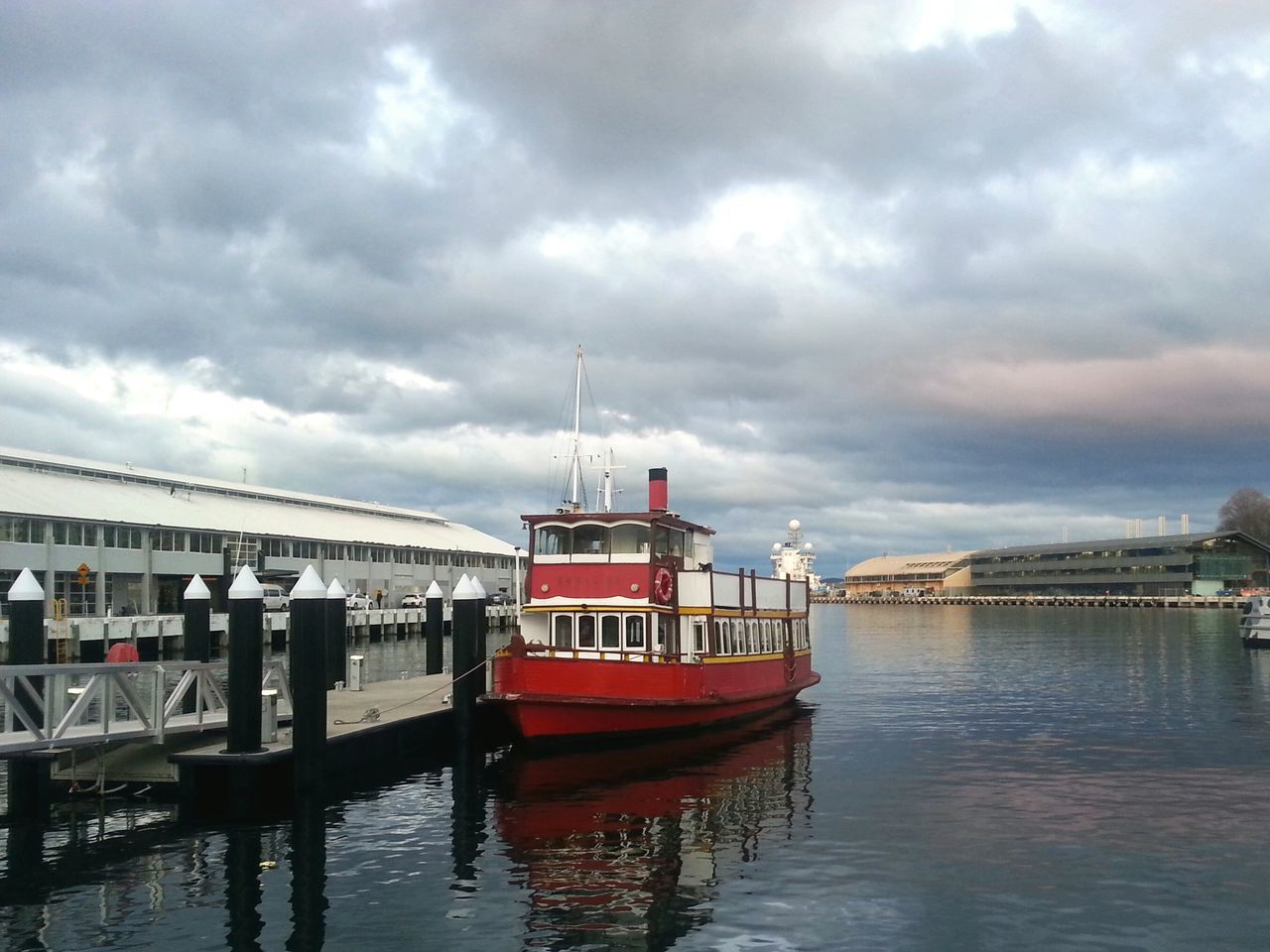 water, sky, cloud - sky, waterfront, architecture, cloudy, built structure, nautical vessel, building exterior, transportation, river, boat, cloud, overcast, pier, weather, mode of transport, sea, lake, moored