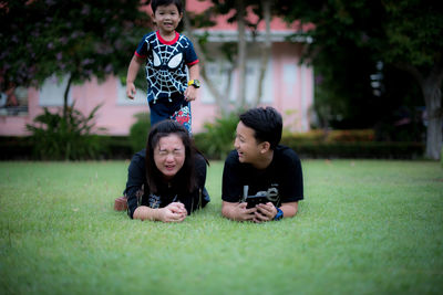 Portrait of happy friends on grass