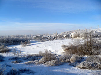 Scenic view of landscape against blue sky