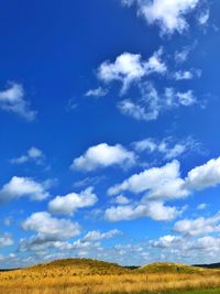 Scenic view of landscape against blue sky