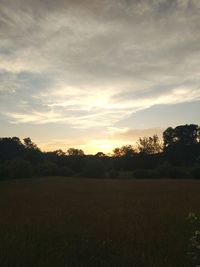 Scenic view of field against sky during sunset