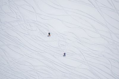 High angle view of people skiing on snowcapped mountain