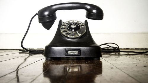 Close-up of old telephone on table