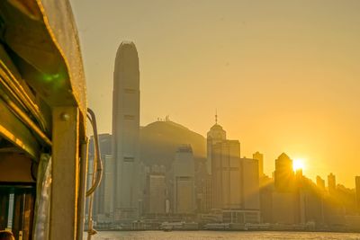 Modern buildings in city during sunset