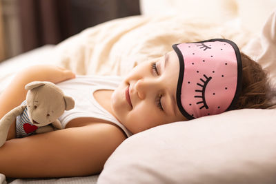 High angle view of young woman lying on bed at home