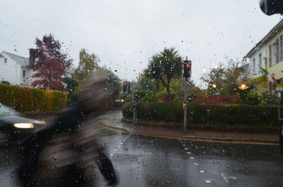 Road seen through wet car windshield