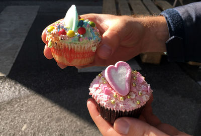 High angle view of hand holding cake