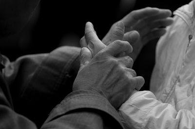 Close-up of baby hands against black background