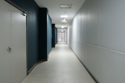 The corridors inside the hospital with bright lights along the way.