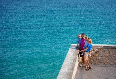 Full length of young woman standing at beach