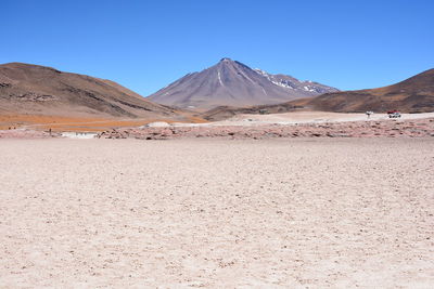 View of desert against blue sky