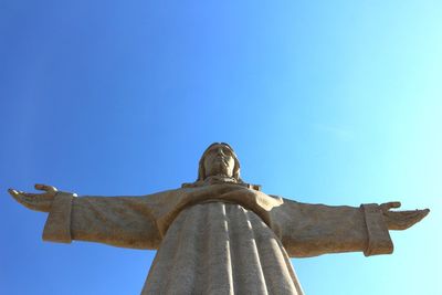 Low angle view of statue against blue sky