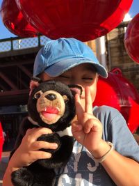 Portrait of woman holding hat