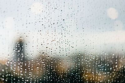 Full frame shot of wet glass window during rainy season