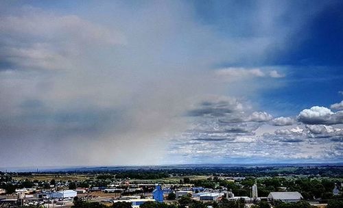 Cityscape against cloudy sky