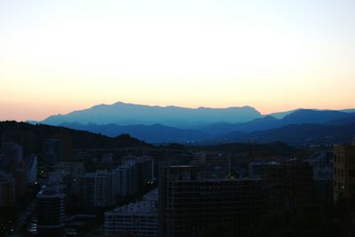 Cityscape with mountain range in background