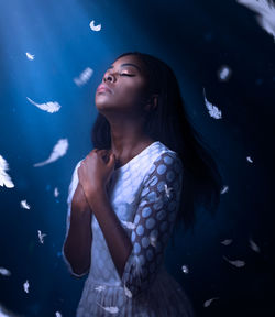 Close-up of young woman looking up in water