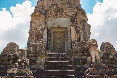 Low angle view of statue against historic building