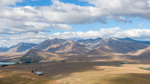 Scenic view of mountains against cloudy sky