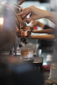 Cropped hand of man holding camera