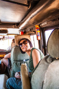 Rear view of a young man sitting in train
